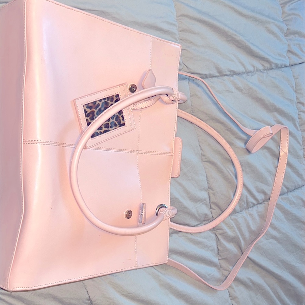 Pink tote purse never been used. Made with genuine leather.